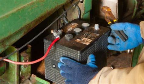 Photo of a tractor battery being checked
