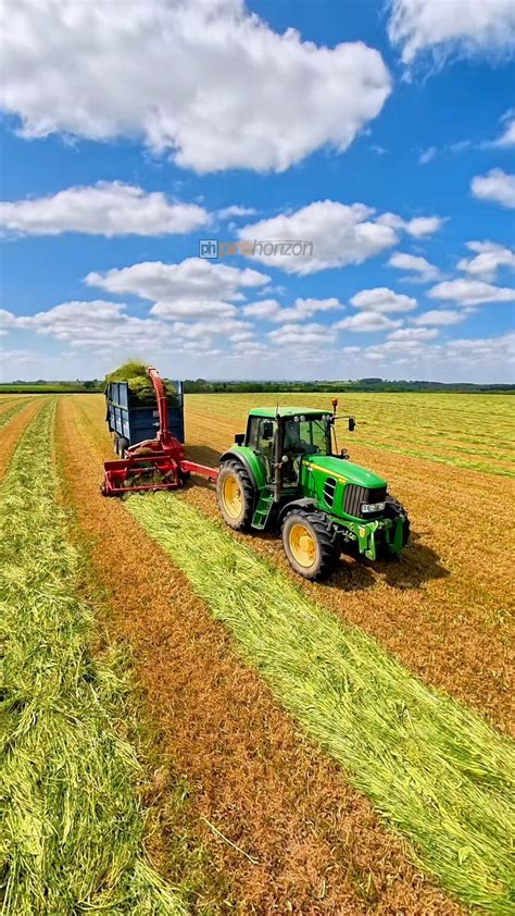 Thematic photo of a tractor with a bale loader at the rear, working on a field