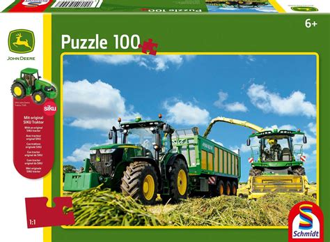 Zdjęcie przedstawiające różnorodne akcesoria z motywem John Deere: puzzle, kubki, kalendarze.