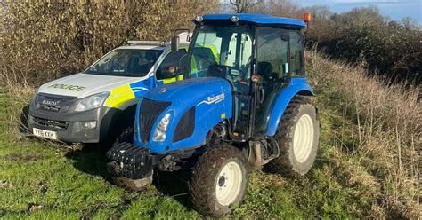 Thematic photo of a stolen tractor being recovered by police in a rural setting
