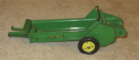 Thematic photo of a child playing with a toy manure spreader