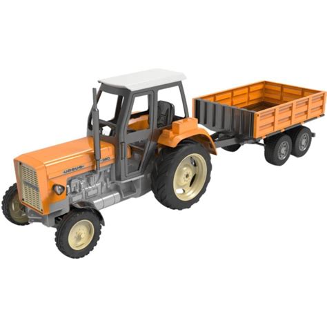 A child playing with a toy Ursus tractor and a Bruder manure spreader