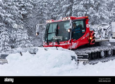 Thematic photo of a snow groomer (ratrak) preparing a ski slope.