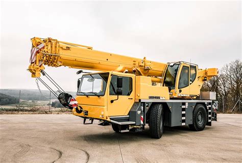 The Liebherr LTM 1040 mobile crane lifting a heavy load on a construction site