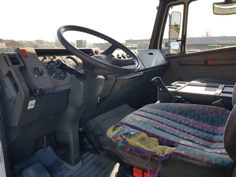 Interior of Mercedes-Benz 814 D cabin from the 90s, focusing on the dashboard and seats