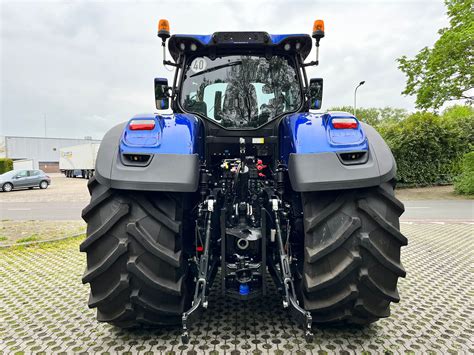The New Holland T7 Blue Power Auto Command tractor on a field with an emphasis on its design and technological features