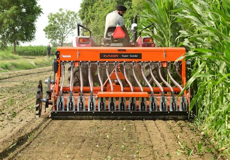 Thematic photo of a farmer adjusting a seeder in the field
