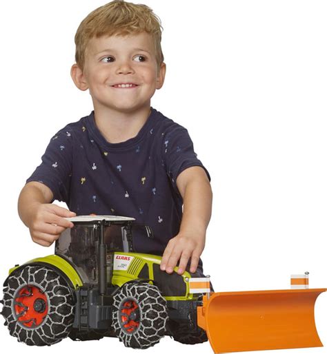 Thematic photo of a child playing with a Bruder toy loader