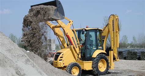 Thematic photo of Komatsu WB97R backhoe loader in action