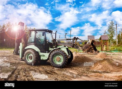 Thematic photo of a front loader working on a farm, showing versatility.