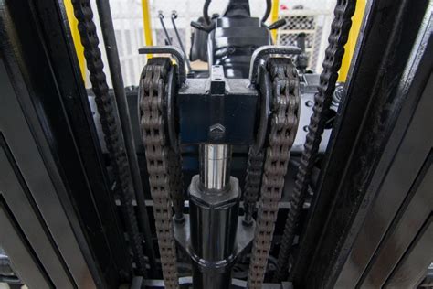 Close-up photo of forklift chains and hydraulic cylinders