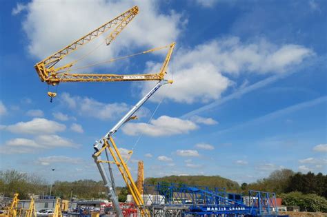 The Potain IGO 50 self-erecting crane at a construction site in an urban environment.