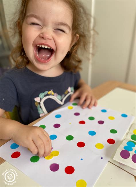 Thematic photo of a child engaged in coloring and sticker activities from a book related to construction