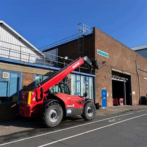 Thematic photo of a Manitou telehandler working on a farm, e.g., loading silage