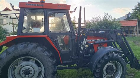 Ciągnik Ursus 4514 z ładowaczem czołowym i widłami do obornika podczas prac polowych