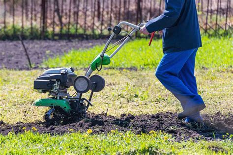 Thematic photo of a person working in the garden with a tiller