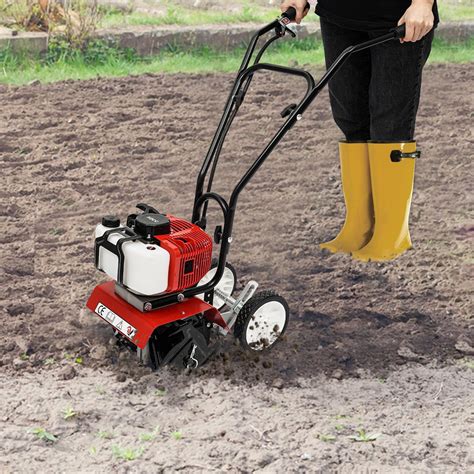 Thematic photo of a person operating a rototiller in a garden bed
