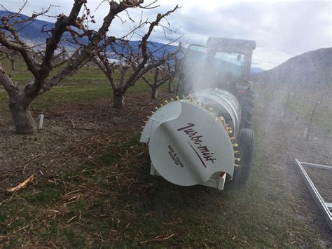 Thematic photo of a fruit sprayer in an apple orchard