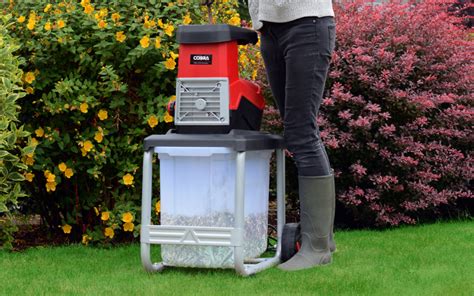 Thematic photo of a ITAMATI shredder in a garden environment, processing branches