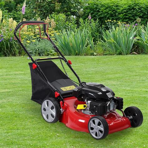 Thematic photo of a petrol lawnmower on a green lawn