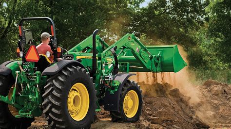 Thematic photo of a front loader attached to a tractor working on a farm