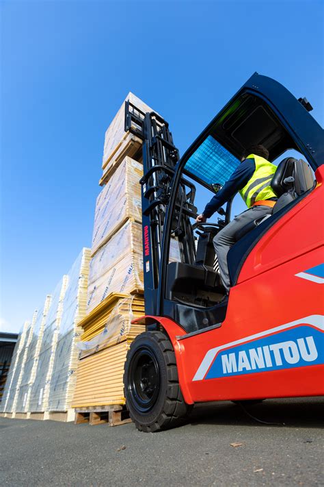 Manitou forklift with attachments working in a warehouse