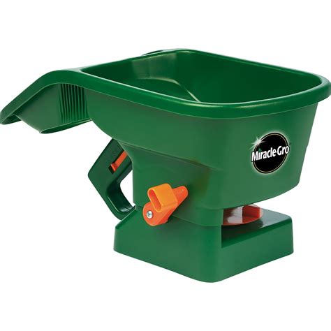 Thematic photo of a person using a hand-held seed spreader in a garden