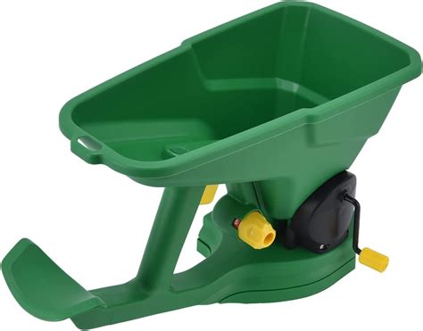Detailed diagram showing the internal mechanism of a hand-held seed spreader with a rotating disc