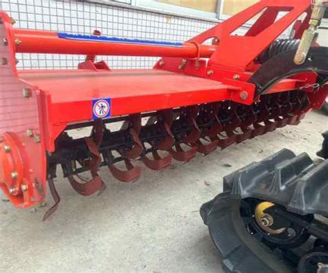 Thematic photo of a rotary harrow with a rubber roller working in the field