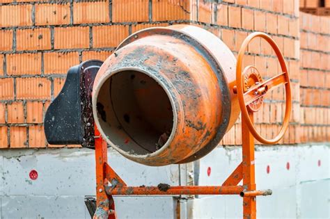 Thematic photo of a construction site with a concrete mixer and building materials