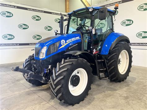 Zdjęcie ciągnika New Holland T5.115 z zamontowanym półgąsienicowym napędem Camso.