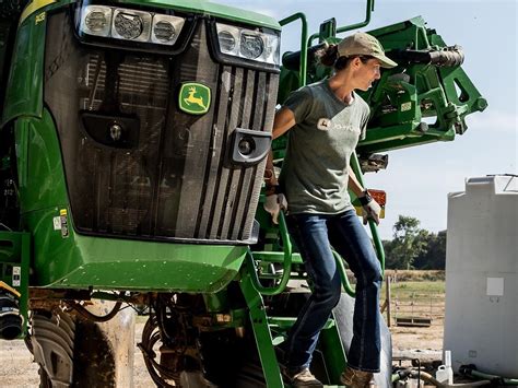 Thematic photo of a person in John Deere clothing in an agricultural setting