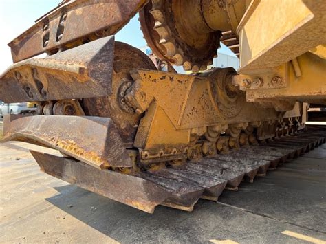 Photo of a worn excavator pin showing damage