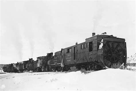 Historic photo of a steam rotary snow plow operating in Poland.