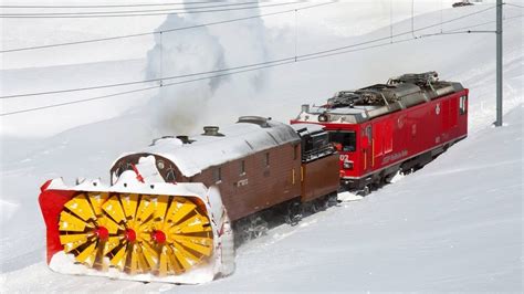 Modern snow plow locomotive in operation on Polish railway tracks.