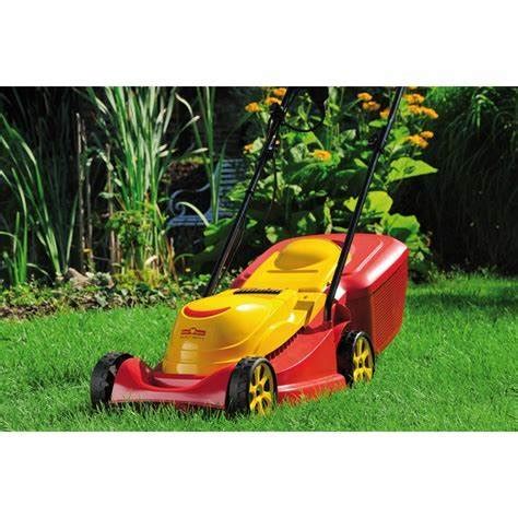 The Wolf Garten A 340 E electric lawn mower in action on a small lawn