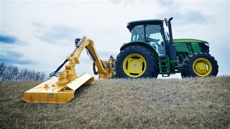 Thematic photo of a tractor with a boom mower working on a slope or ditch