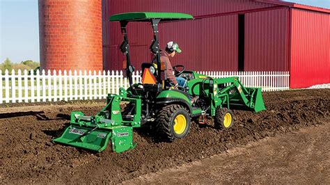 Thematic photo of a tractor with a rotary tiller attached to it, working in the field