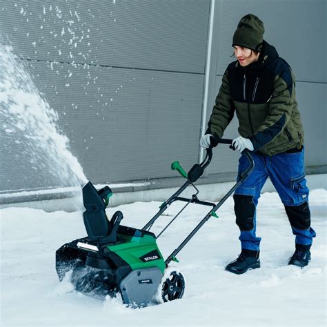 Product photo of Stalco SBS40BL snowblower in action, showing its snow-throwing capability.