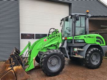 Photo of a Terex TL70S loader with its lifting system tilted