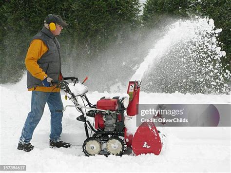 Thematic photo of a person operating a snowblower