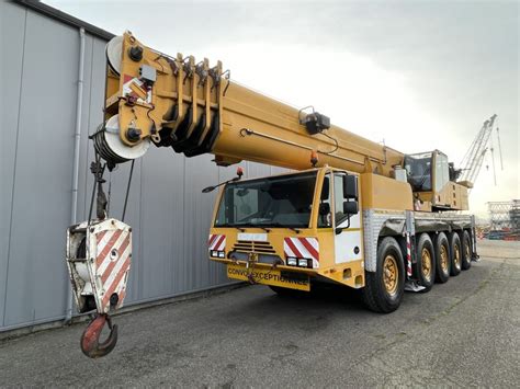 Zdjęcie nowoczesnego dźwigu samojezdnego Terex Demag AC100, podkreślające jego rozmiar i możliwości.