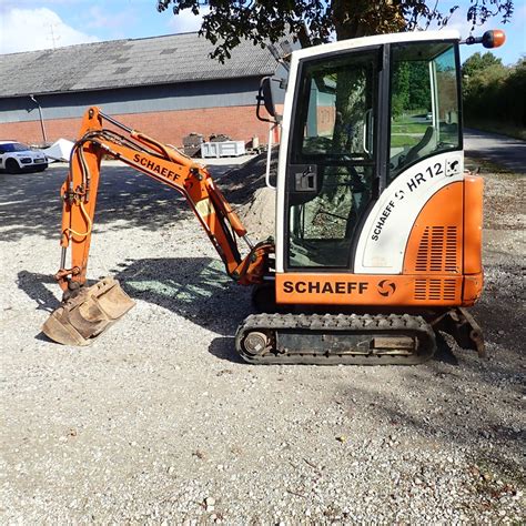 Photo of a Schaeff HR12 excavator with new stickers on the hood