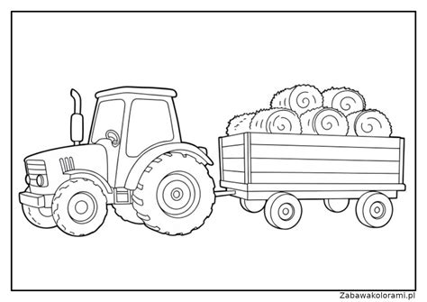 Młody rolnik prowadzący traktor z przyczepą na polu
