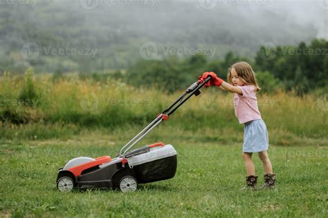 Thematic photo of a lawnmower on a green lawn with a background of mountains (Szczyrk)