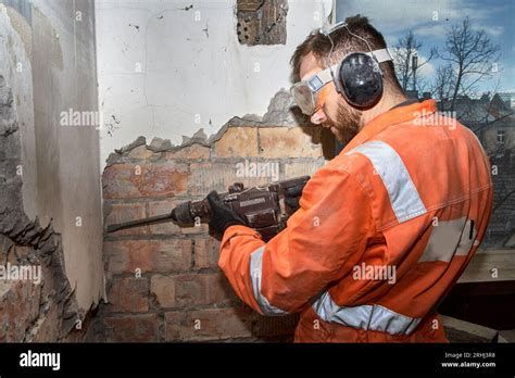 Thematic photo of a person operating a demolition hammer