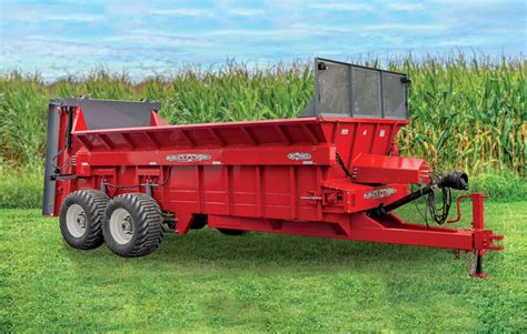 Thematic photo of a modern manure spreader on a tandem chassis in operation on a field