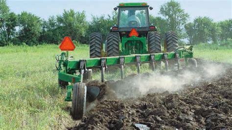 Thematic photo of a modern reversible plow working in a field