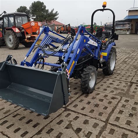 Ciągnik Farmtrac z ładowaczem czołowym w pracy
