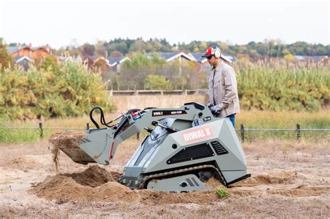 Thematic photo of a skid-steer mini loader operating in a confined space, e.g., an animal barn or a construction site.